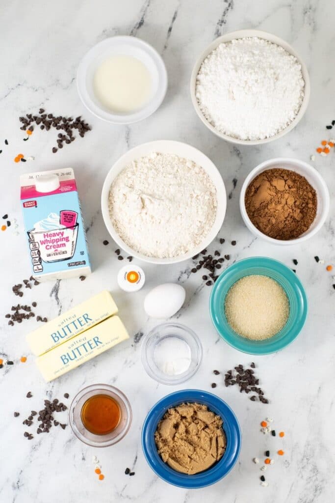 all ingredients for chocolate cookie bars on marble counter 