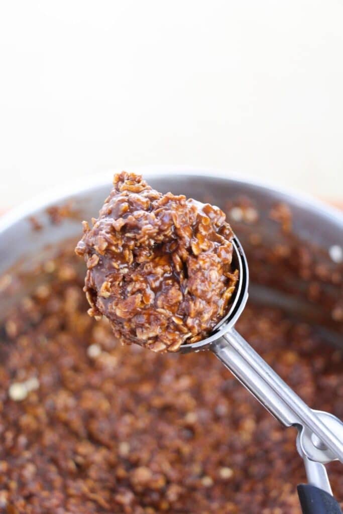 oatmeal no bake cookie on a cookie scoop above pot