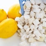 puppy chow coming out of a bowl with lemons beside it