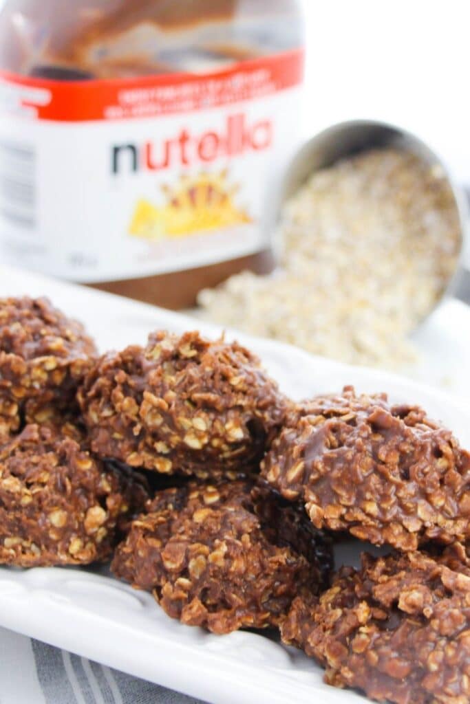 platter with no bake cookies. Oatmeal spilled on counter behind and Nutella jar as well sitting 