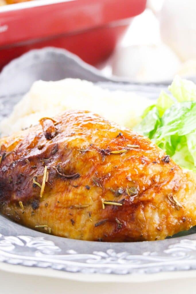 roast chicken on a plate with salad as well