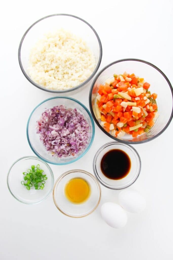 ingredient for cauli rice all in glass bowls on counter 