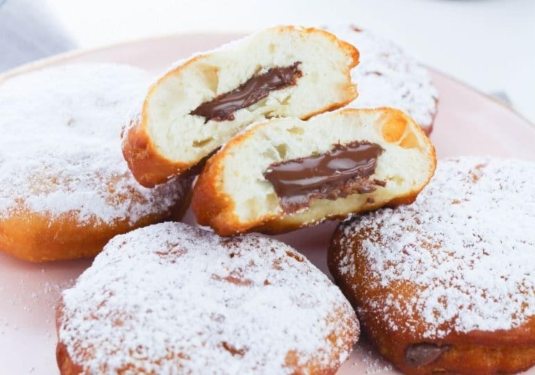 donuts on a plate with one cut in half