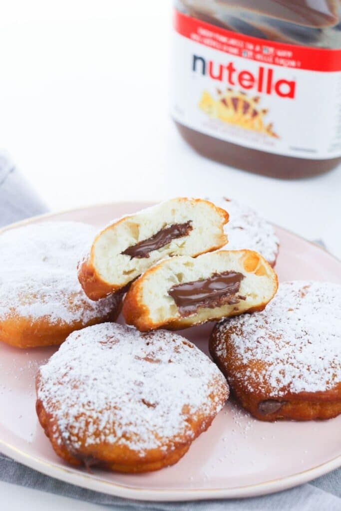 plate of donuts with Nutella in the back