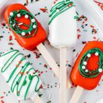 cakesicles on a plate with sprinkles around it