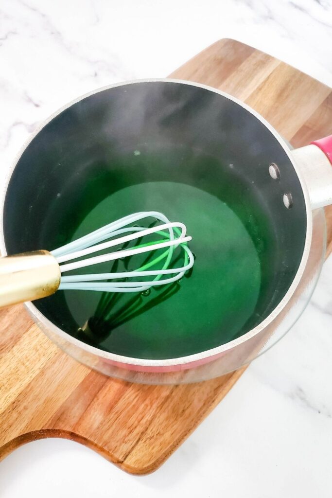 mixing Jello in a pot until dissolved 