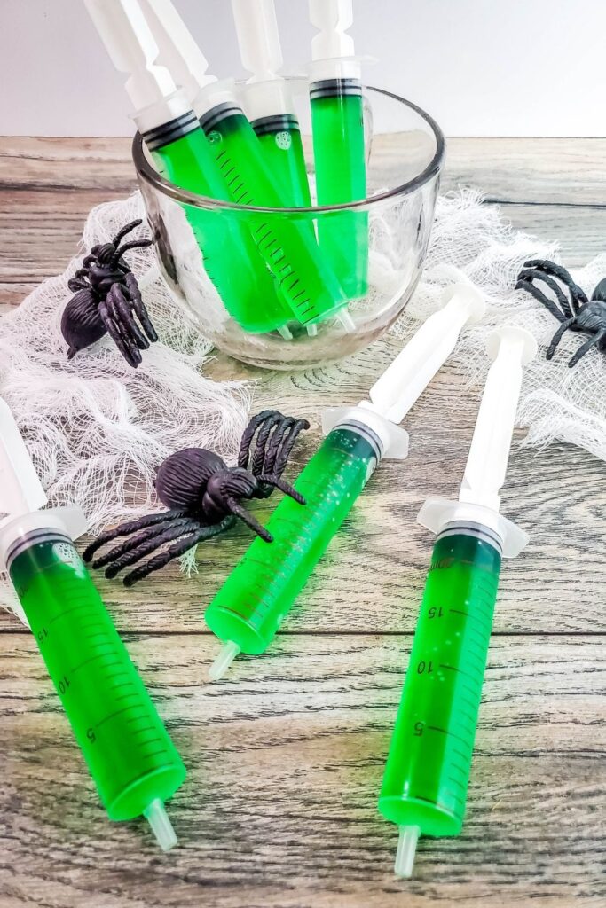 Halloween syringes on wooden counter 