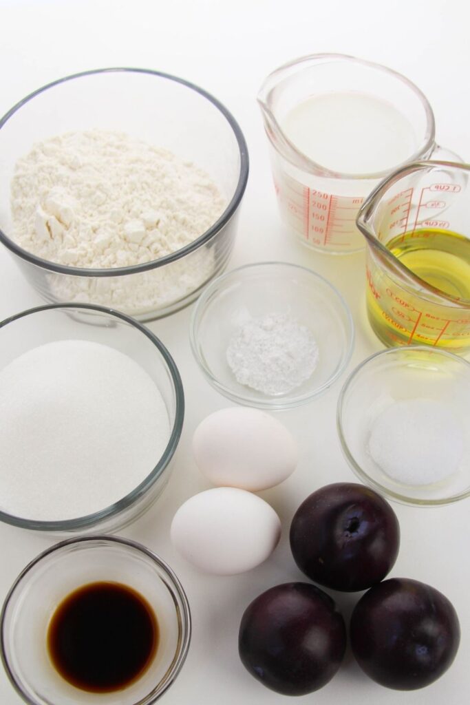 ingredients for sugar plum cupcakes in glass containers on white counter 