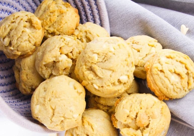 White Chocolate Macadamia Nut Cookies on counter spread out