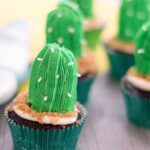 cactus cupcakes on a counter