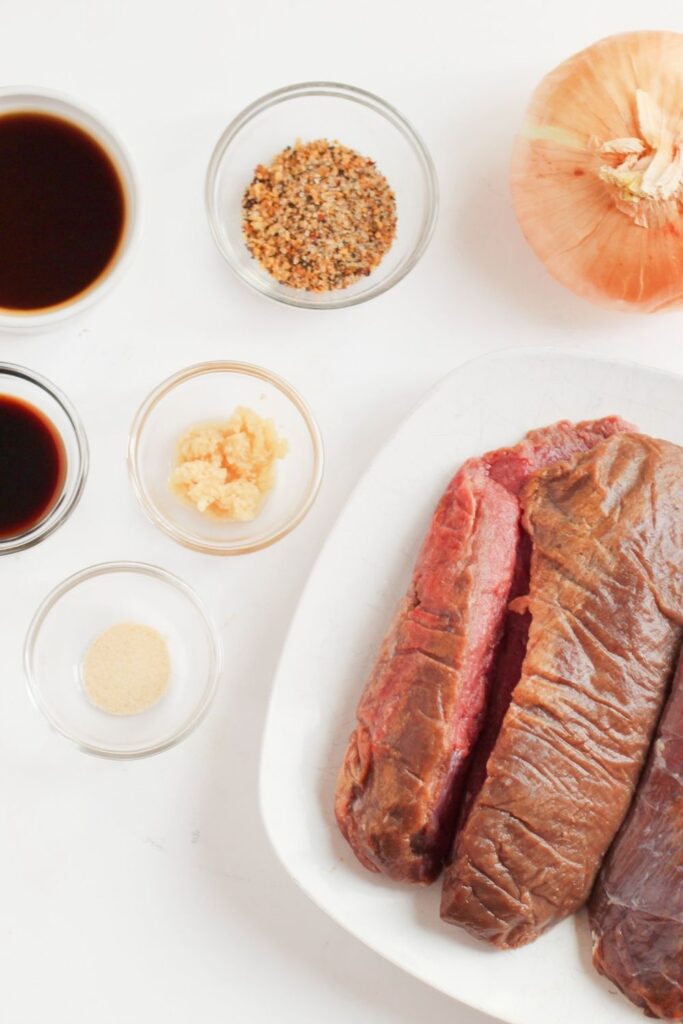 ingredients for deer roast on counter in glass bowls 