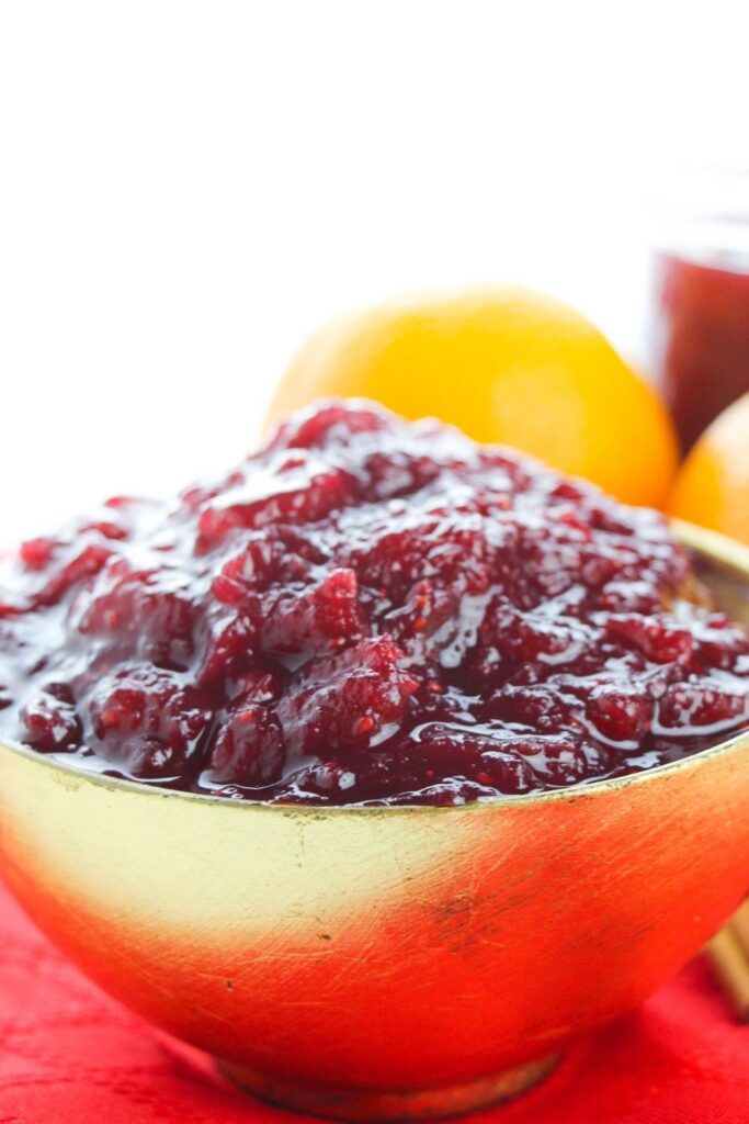 homemade cranberry sauce in bowl on red table cloth