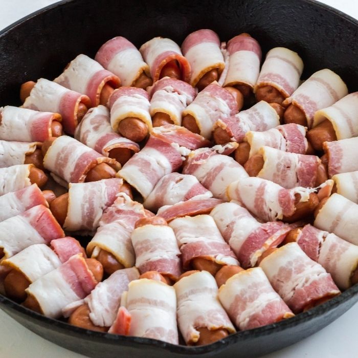 bacon wrapped lil't smokies in cast iron skillet 