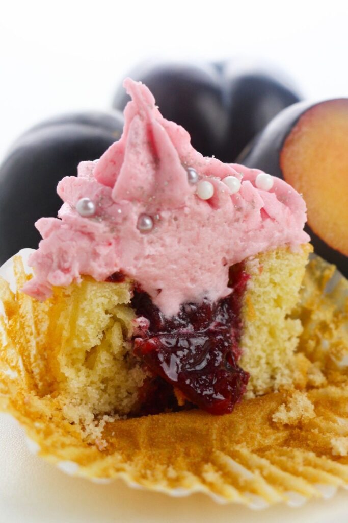 cupcake sliced in half with fruit filling in center 