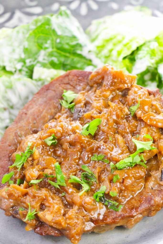 gravy on steak with garnish 