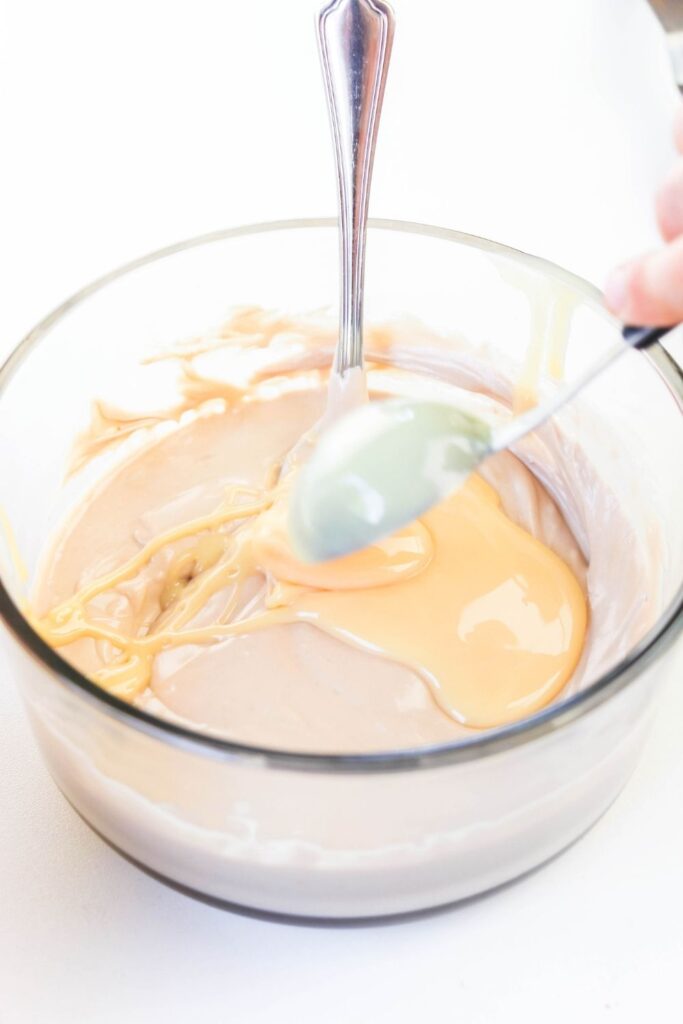 caramel fudge being mixed in a bowl 