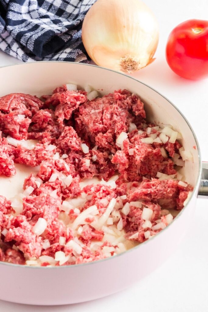 hamburger and onion in a pan cooking