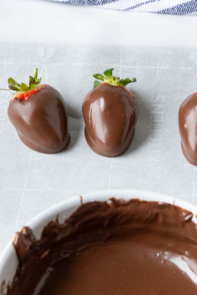 dipped strawberries on parchment paper