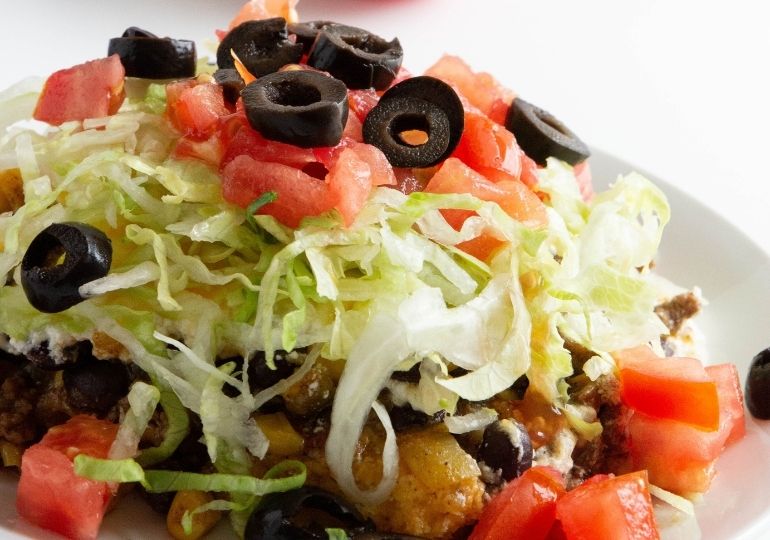 cornbread taco bake on plate with tons of toppings