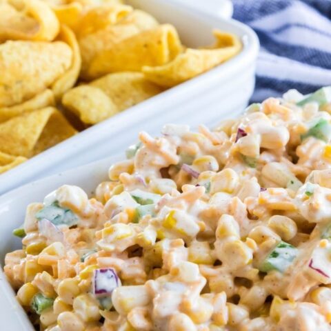 corn dip in container with chips by it