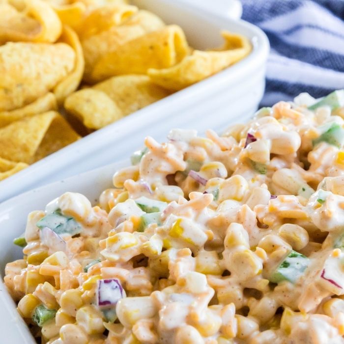 corn dip in container with chips by it 