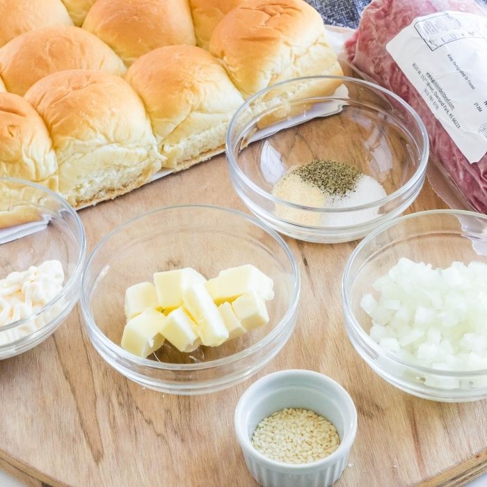 hamburger slider ingredients on wooden cutting board 