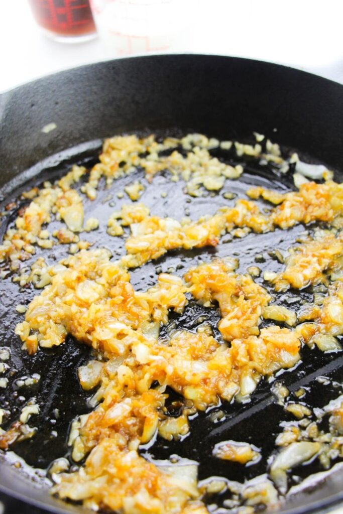 onions and garlic sauted in a pan on the stove 