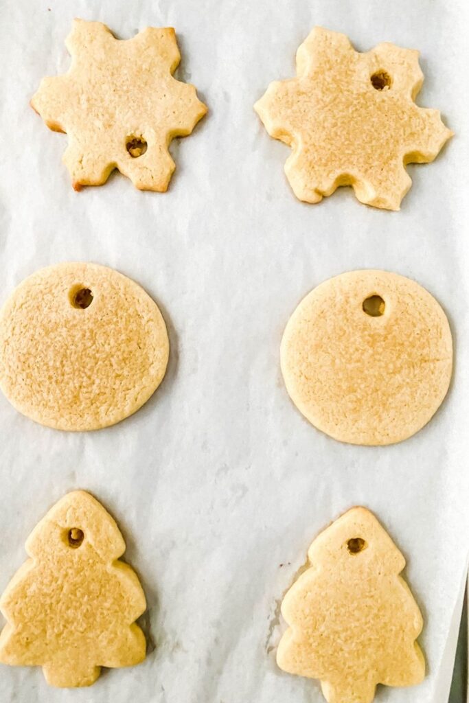 Ornament Sugar Cookies on parchment paper lined pan 