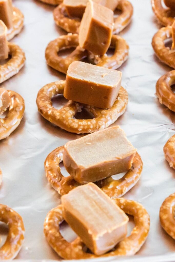 caramel pretzels on an aluminum foil tray