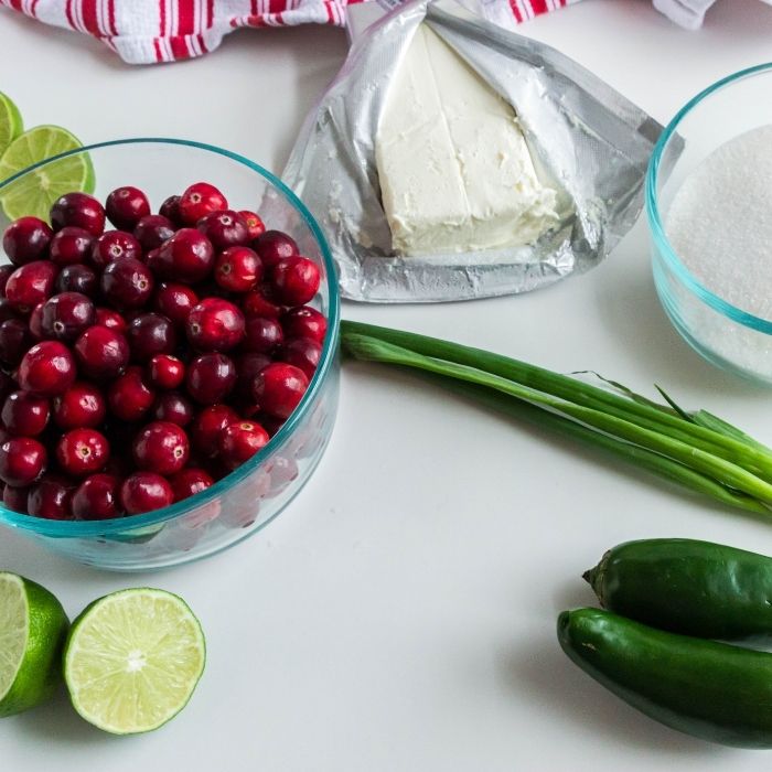 ingredients for cranberry salsa on white counter 