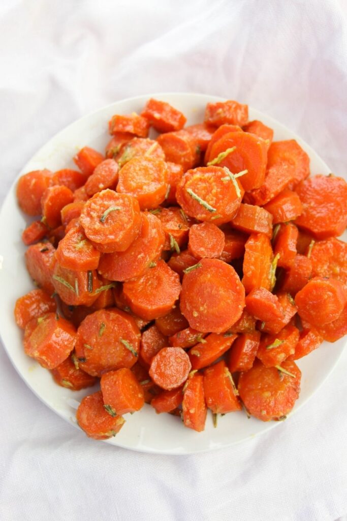 glazed carrots on plate on white counter 