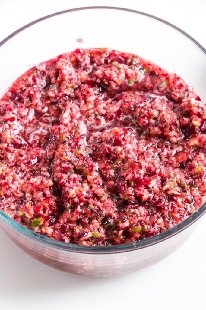 jalapeno cranberry salsa in a glass bowl on white counter 