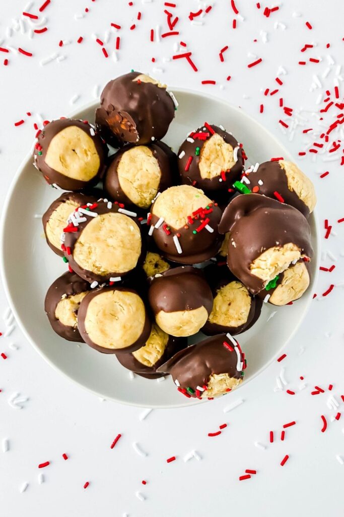 christmas buckeyes on platter with sprinkles around it 