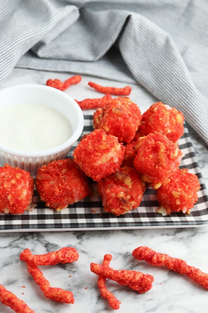 cheese bites on a black checkered plate 