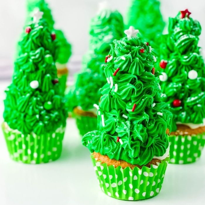 christmas tree cupcakes on white counter 