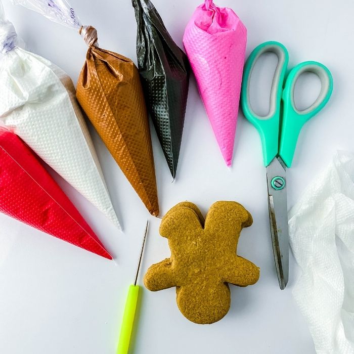 royal icing and cookies on white counter 