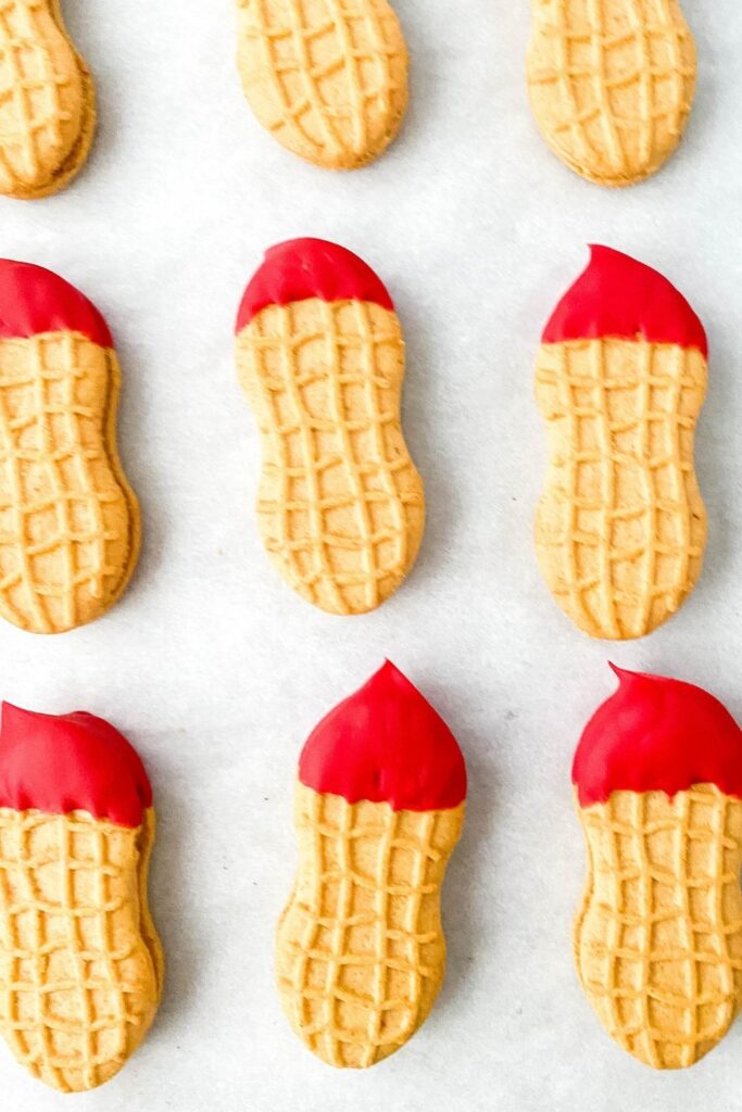 red dipped cookies on parchment paper for Santa cookies 