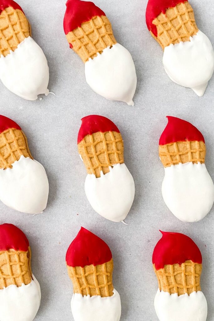 nutter butter santa cookies on parchment paper 