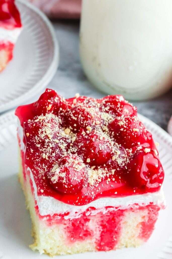 boxed cake topped with cherry pie filling and graham cracker crumbs 