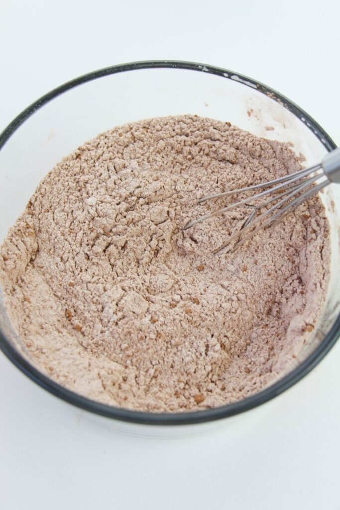 cake mix in a pyrex bowl with whisk