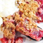 cherry crisp on a plate with ice cream