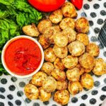 crispy tortellini on tray with marinara beside it in a bowl