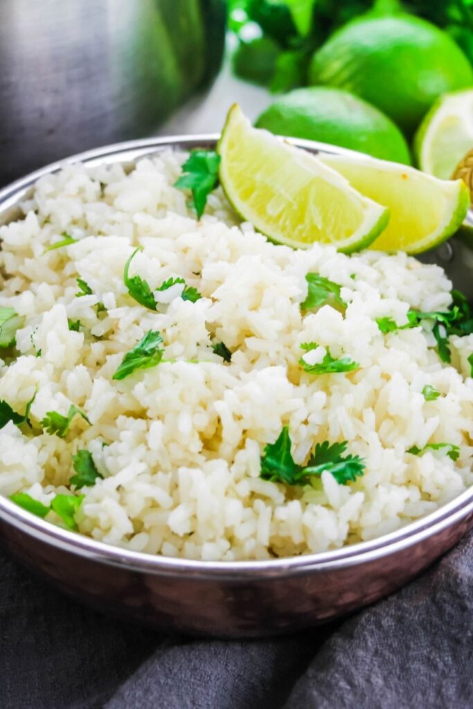 cilantro rice in a bowl with lime wedges 