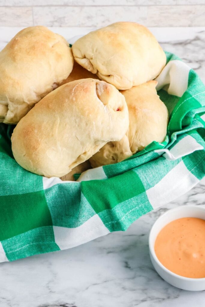 reuben rolls in a basket on marble counter