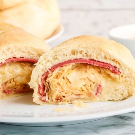 reuben roll up cut in half on plate