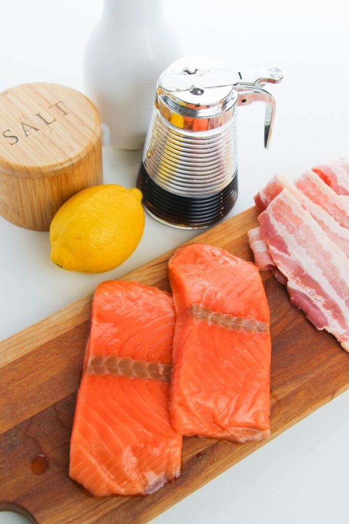 salmon, bacon, lemon and more on white table