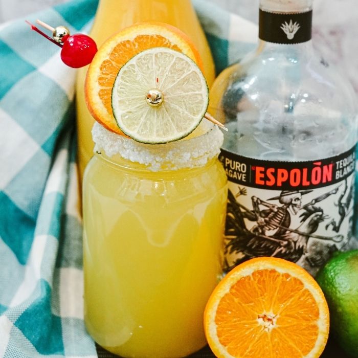 tequila orange juice on table with towel behind it 