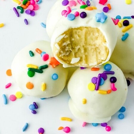 cookie truffles with sprinkles all around it on table