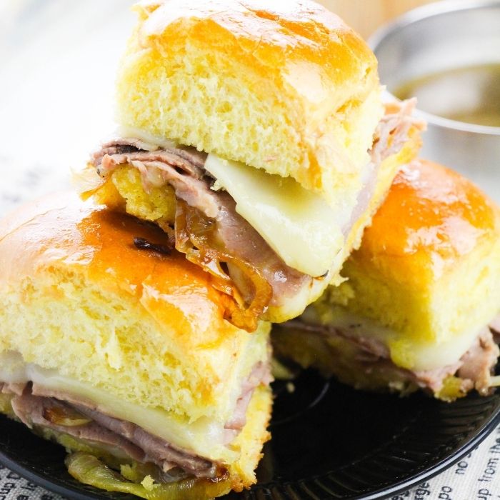 hawaiian roll roast beef sliders stacked on top of each other 