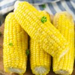 corn on the cob on wooden cutting board